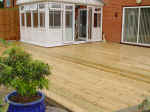 Large flat garden timber decking project in Kent. Uneven garden patio replaced with timber decking