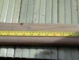 Tape measure on top rail of decking balustrade