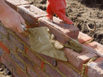 Cleaning the brick course of surplus mortar